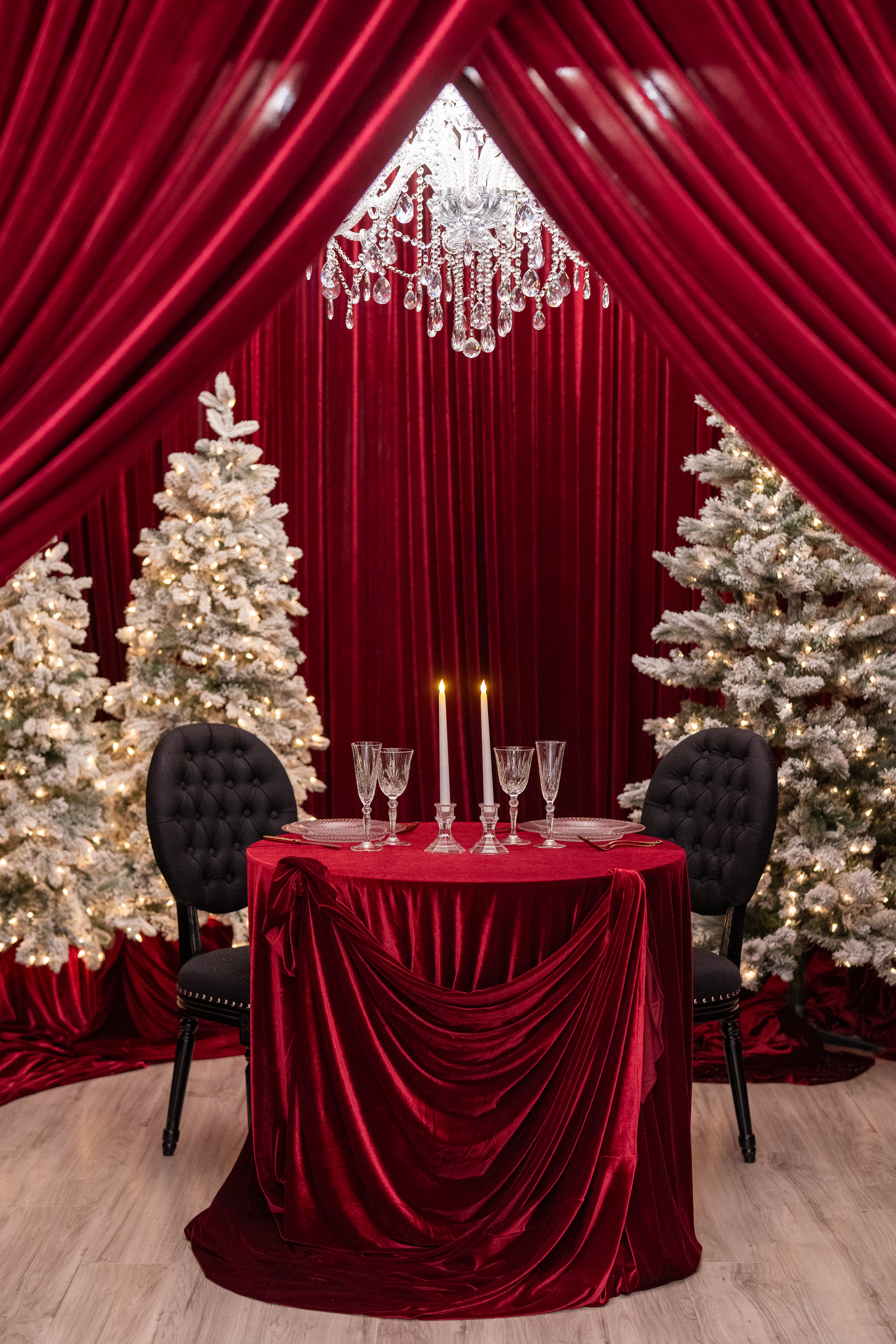 dinner for two, burgundy draped holiday setup with flocked Christmas trees